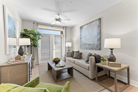 a living room with a couch and a ceiling fan